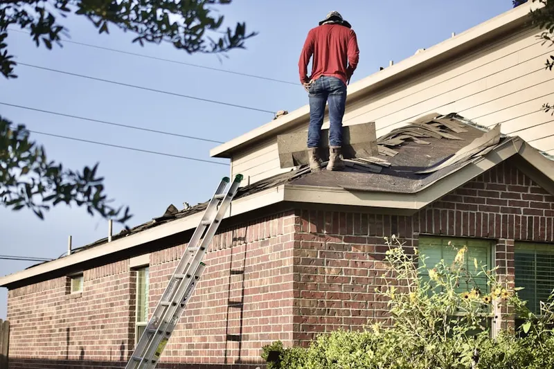 Professional roofer working on a residential roof in Burlington Town Center